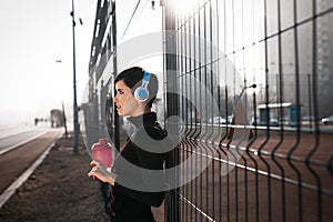 Woman listening to music while working out and jogging outdoor