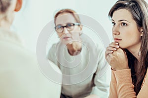 Woman listening to therapist during training for businesswoman in the office