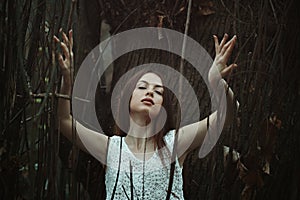 Woman listening the wind in the woods