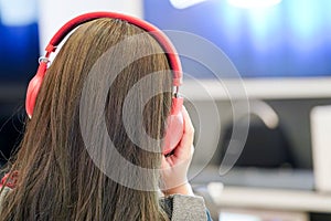 Woman listens music with her red headset