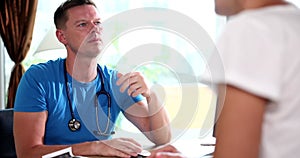 Woman listens to a professional doctor's consultation, visits experienced male doctor in private clinic