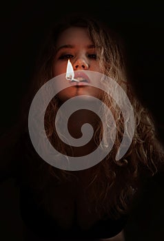 Woman with lit match in mouth photo