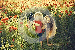 Woman and little boy or child in field of poppy