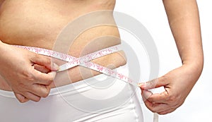 Woman with little fat measuring her stomach