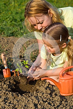 Woman and little girl in the garden