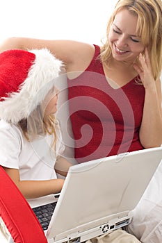 Woman and little girl playing with a laptop