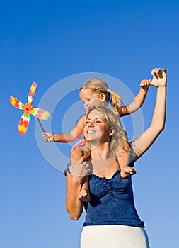 Woman with little girl playing outdoors