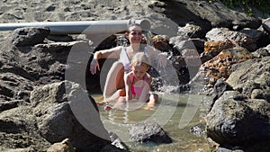 Woman and little girl relaxing in thermal waters