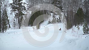 Woman and Little Girl Riding on a Sledding Tubing