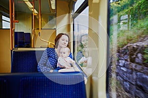 Woman with little girl travelling by train