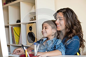 Woman and little girl using computer