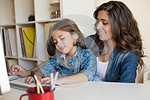Woman and little girl using computer