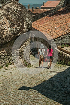 Woman and little girl walking down an alley at Monsanto