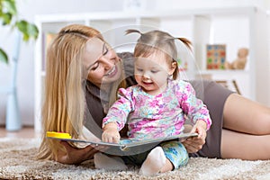 Woman and little girl watching a baby booklet