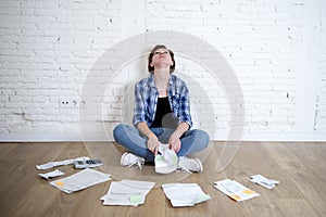 Woman at living room floor with calculator and bank and bills paperwork and documents doing domestic financial accounting