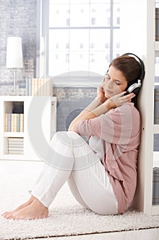 Woman on living room floor with headphone