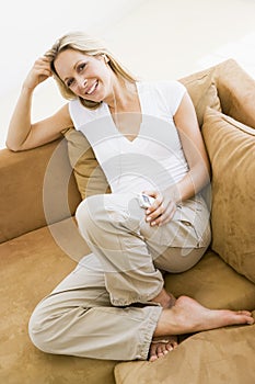 Woman in living room listening to MP3 player