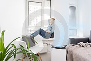 Woman In Living Room Using Air Cleaner And Humidifier