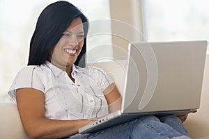 Woman in living room using laptop