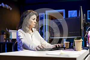 Woman in living room working from home coding
