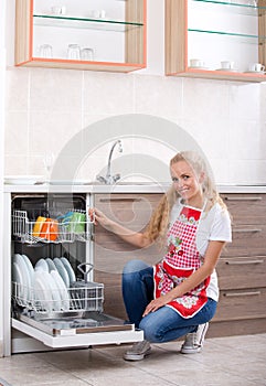 Woman loading dishwasher