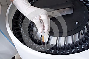 Woman loading samples in analyzer