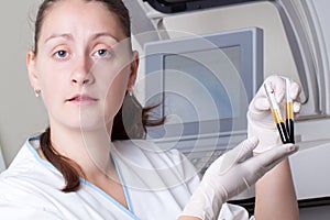 Woman loading samples in biochemical analyzer