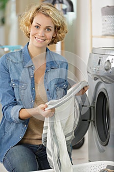 woman loading washing machine