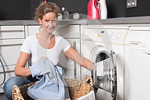 Woman loading washing machine