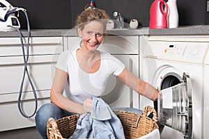 Woman loading washing machine