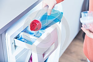 Woman loading washing machineWoman Loading Dirty Clothes In Washing Machine For Washing