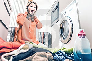 Woman loading washing machineWoman Loading Dirty Clothes In Washing Machine For Washing