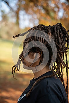 Woman with locs wrapped shot from the side