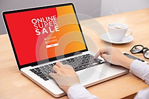 Woman login with password on laptop computer for shopping online website with promotion sale discount campaign on screen.