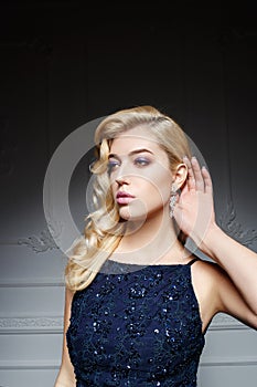 woman with long blond hair in dark blue dress