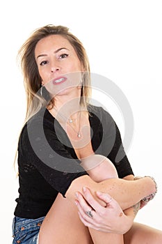 Woman with long blonde fair hair dressed casually looking camera  isolated against blank studio background