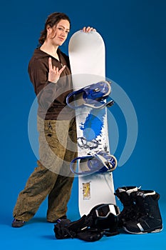 Woman with long curly hair giving a hang loose