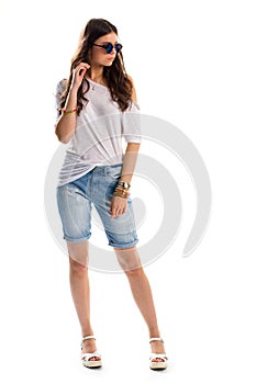 Woman in long denim shorts.