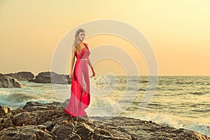 Woman in long dress in front of sea