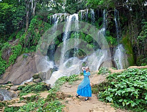 Woman in a long dress near waterfalls Soroa, Pinar del Rio, Cuba photo