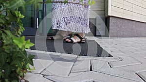 A woman in long ethnic skirt walking inside an office center or modern shopping mall, beautiful entrance of a building