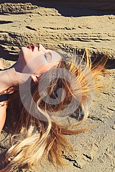 Woman with long hair, hairstyle relax on sand