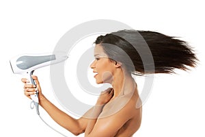 Woman with long hair holding blow dryer