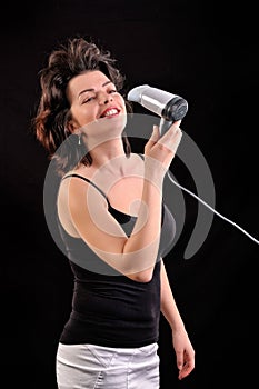 Woman with long hair holding blow dryer