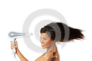 Woman with long hair holding blow dryer