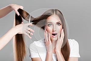 Woman with long hair holds scissors