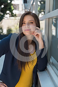 Woman with long hair posing with hand on her face