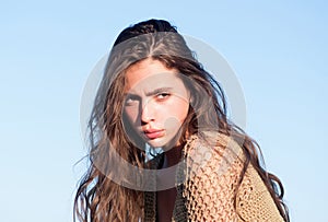 Woman with long hair on sunny blue sky. Woman with natural makeup look.