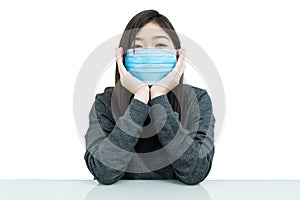 Woman long hair wearing protective mask and propping up chin with his hands