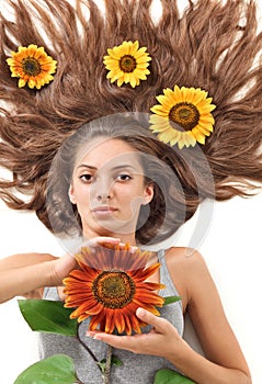 Woman with long hairs and sunflower